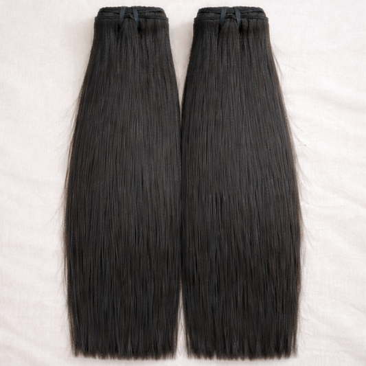 Two bundles of black hair extensions on a white background